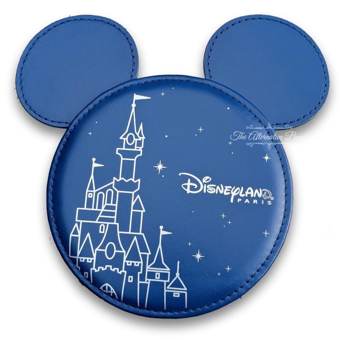 Blue disc with Disneyland Paris castle design on a white background