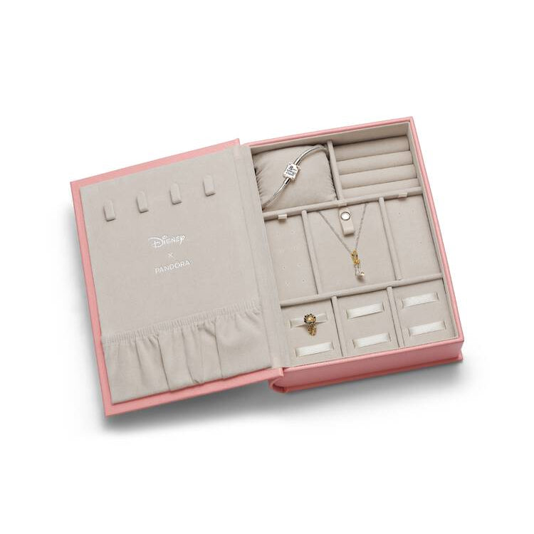 Open jewelry box with various necklaces and a ring on a white background