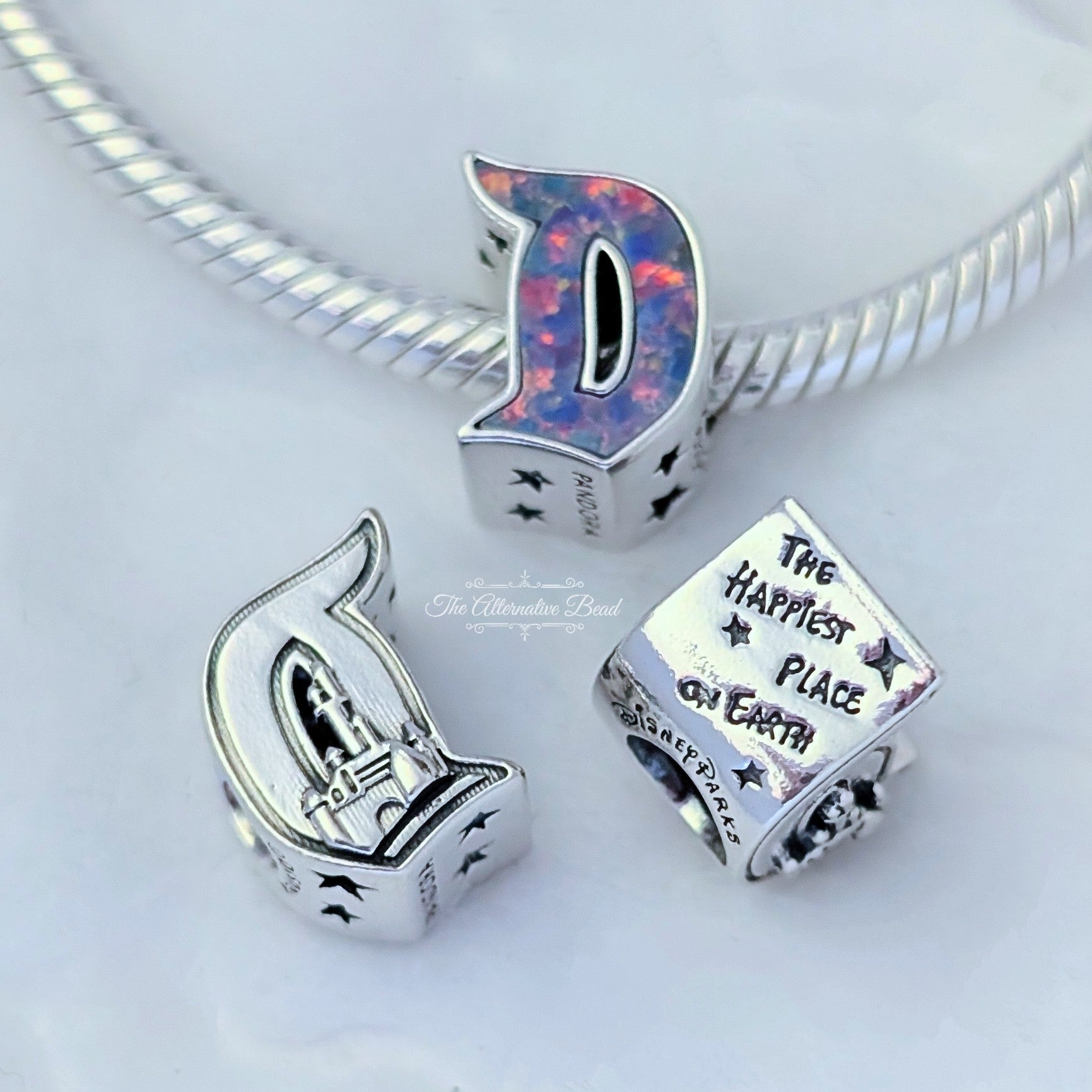 Disney x Pandora D Disneyland Logo Charm multicolor and silver and pink and purple sterling-silver and enamel Bead by The Alternative Bead. Your official Disney x Pandora Retailer from Germany