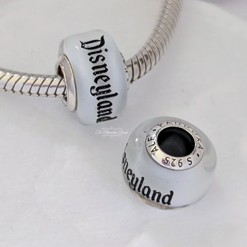 Disney x Pandora Disneyland Glass bead Charm silver and white sterling-silver and glass Bead by The Alternative Bead. Your official Disney x Pandora Retailer from Germany