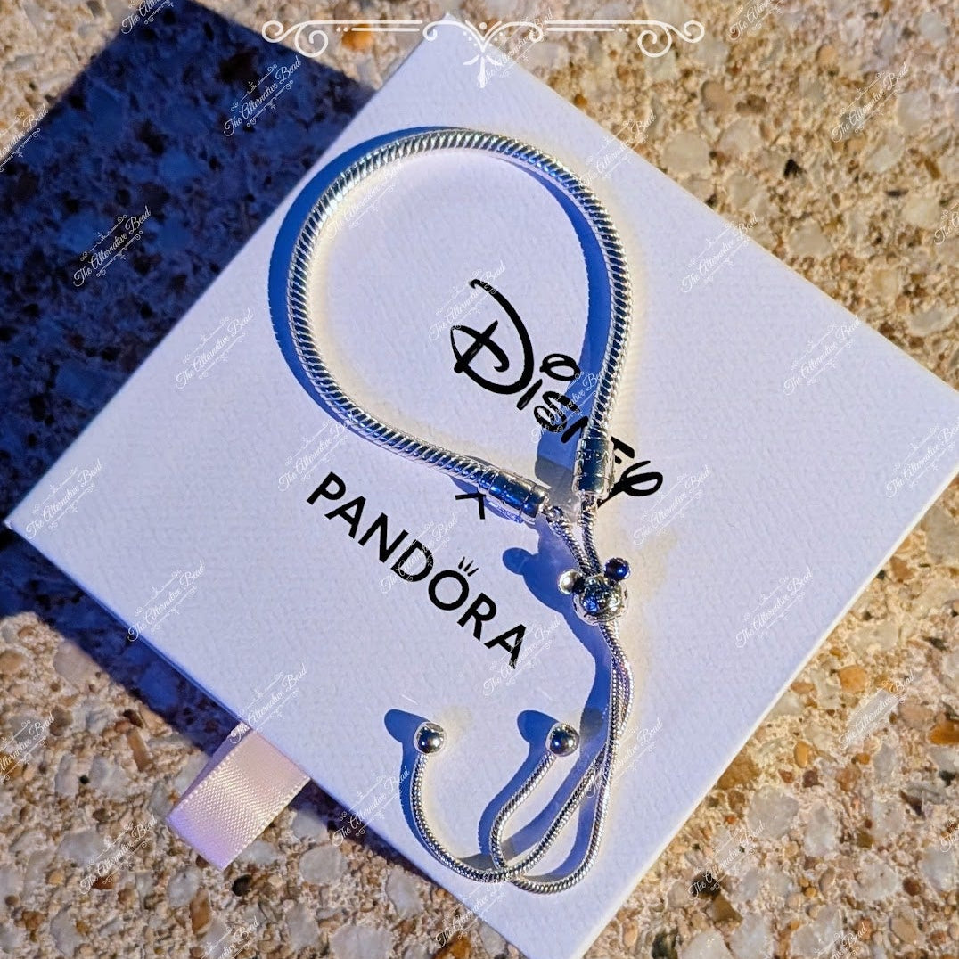 Pandora charm on a card with 'The Alternative Bead' branding on a textured surface.