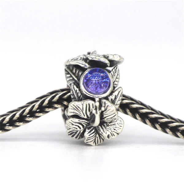 VIP-CHARMS Hibiscus Stopper Spacer Charm Bead silver; blue glass; natural-stone; sterling-silver Stopper by The Alternative Bead. Your official VIP-CHARMS Retailer from Germany