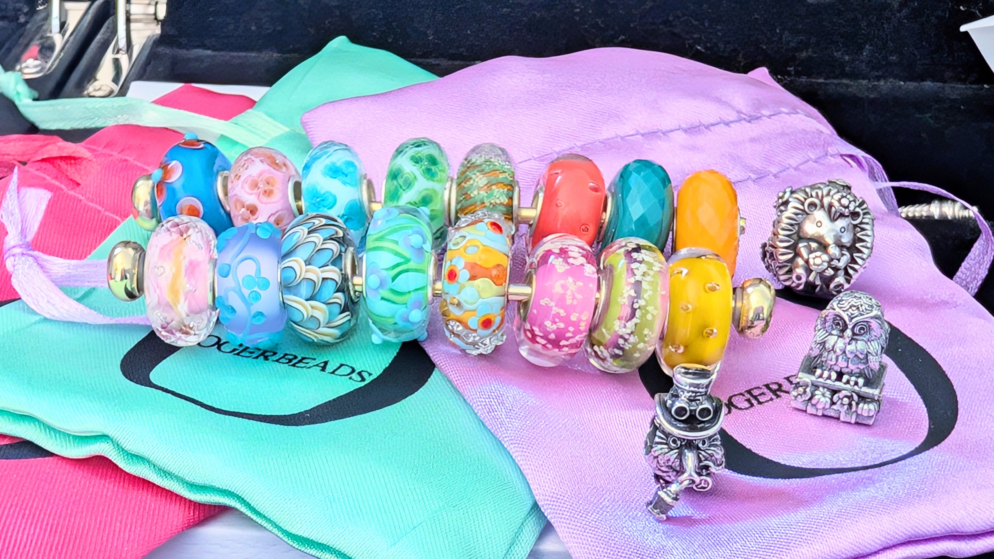 Some Ogerbeads Charms on Ogerbeads Pouches by The Alternative Bead