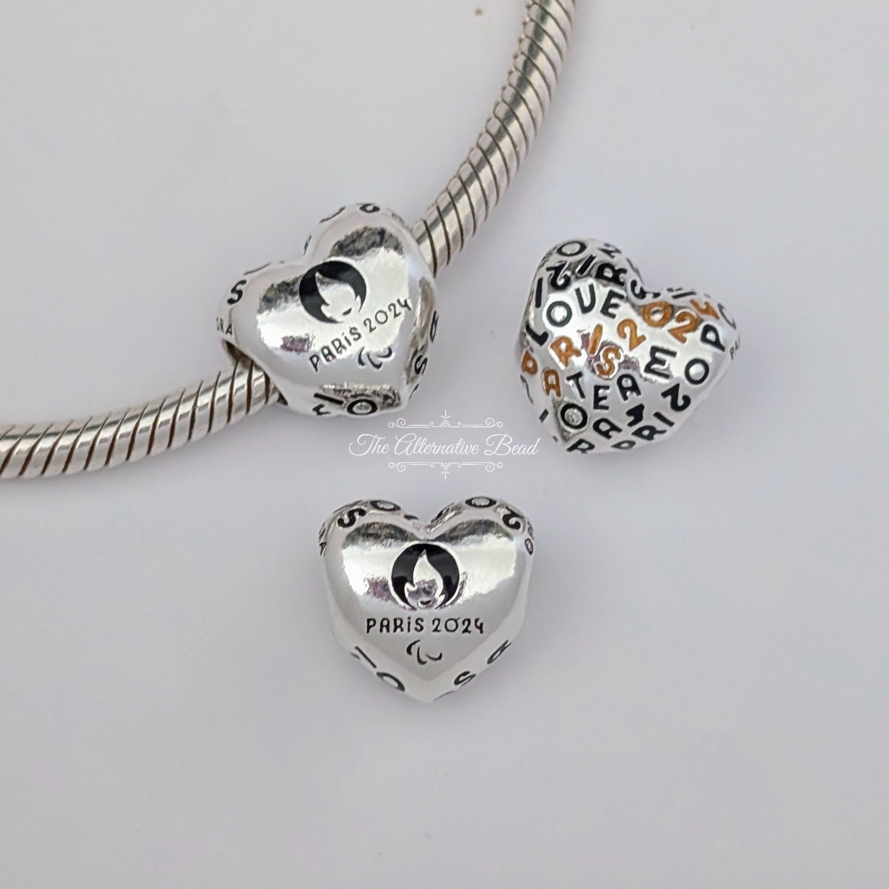 Pandora Paris 2024 Paralympic Games Heart Charm (793468C01) silver and black and gold sterling-silver and resin Bead by The Alternative Bead. Your Jewelry Retailer from Germany
