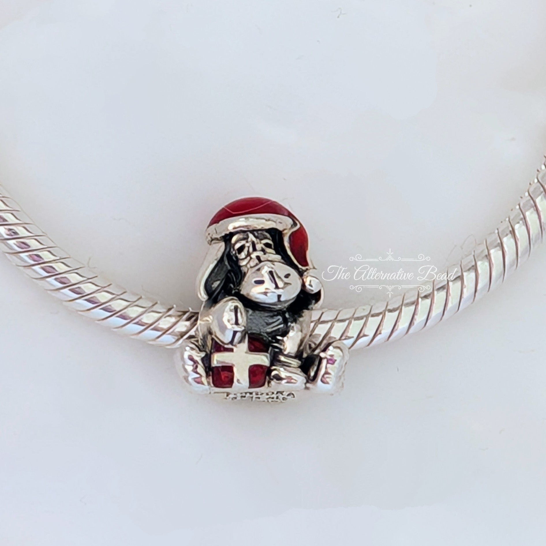 Disney x Pandora Eeyore Christmas Charm (798449C01) silver and red sterling-silver and enamel Bead by The Alternative Bead. Your Jewelry Retailer from Germany