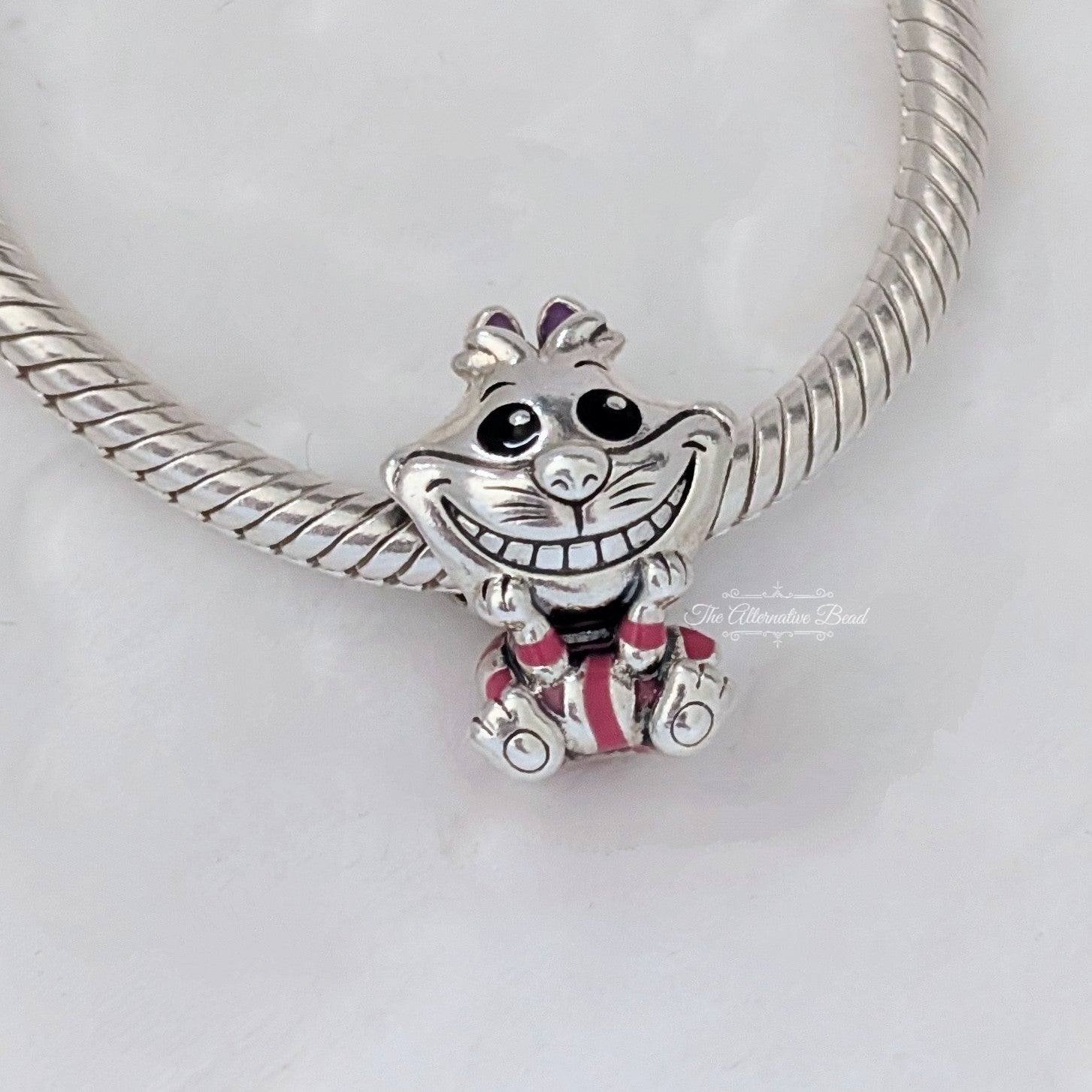 Disney x Pandora Alice in Wonderland Cheshire Cat Charm (798850C01)) silver and pink and purple sterling-silver and enamel Bead by The Alternative Bead. Your Jewelry Retailer from Germany