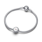 Silver bracelet with round charms on a white background