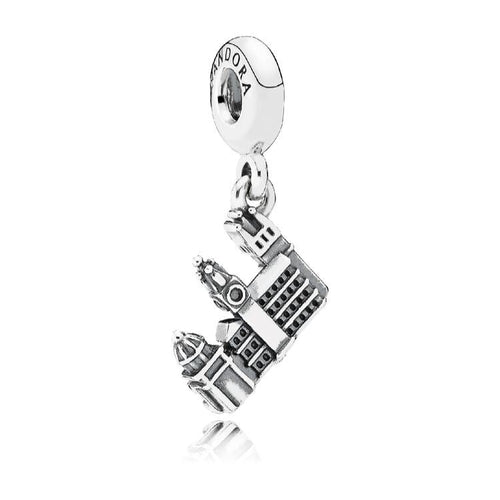 Silver charm with a detailed design on a white background