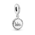 Silver charm with a detailed design on a white background
