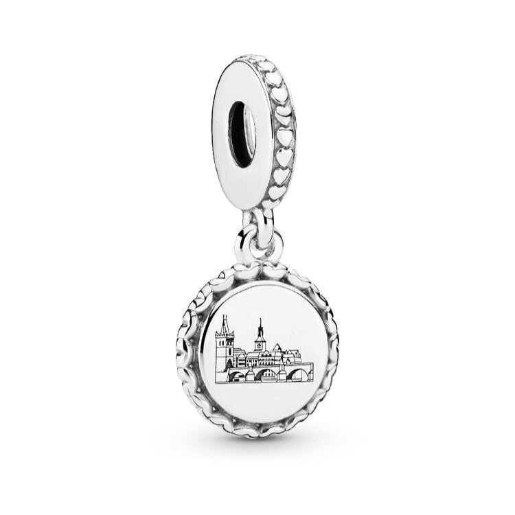 Silver charm with a detailed design on a white background