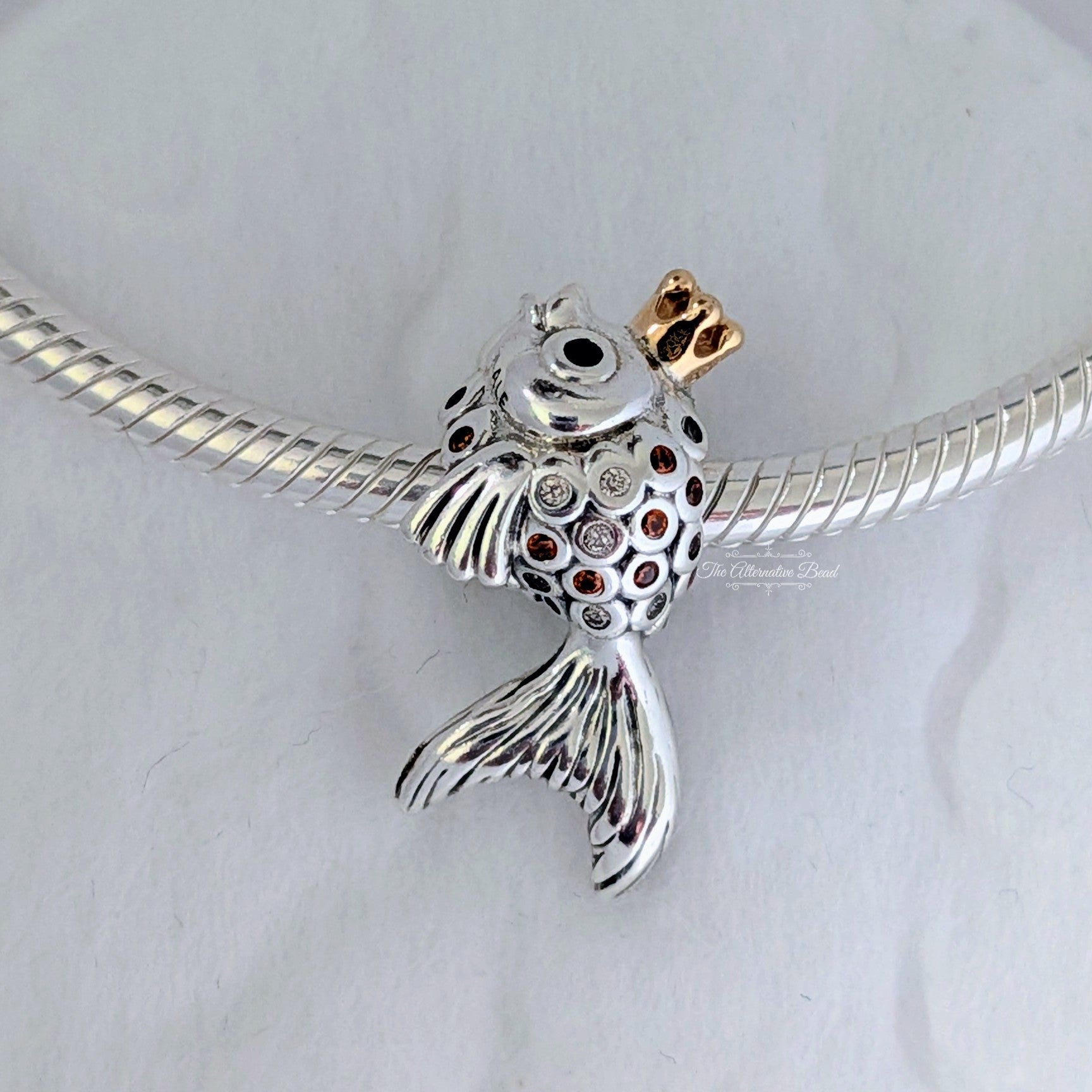 Pandora Fairytale fish silver charm with 14k, orange and golden coloured cubic zirconia and black crystal silver and gold sterling-silver and gold and crystal Bead by The Alternative Bead. Your Jewelry Retailer from Germany