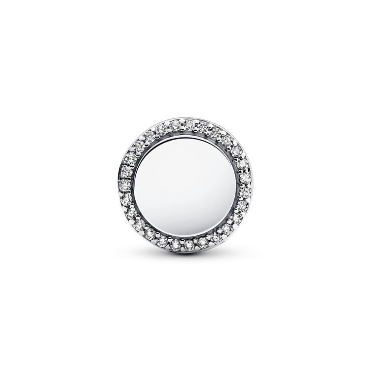 Silver charm with a white gemstone on a white background