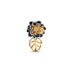 Gold and black floral earring on a white background