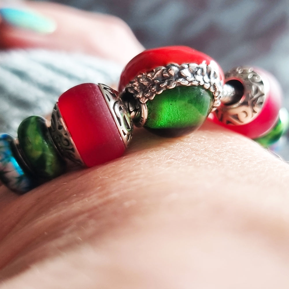 Aurora Charm Santas Red Hat Glass Bead silver; red; green sterling-silver; enamel; glass Bead by The Alternative Bead. Your official Aurora Charm Retailer from Germany