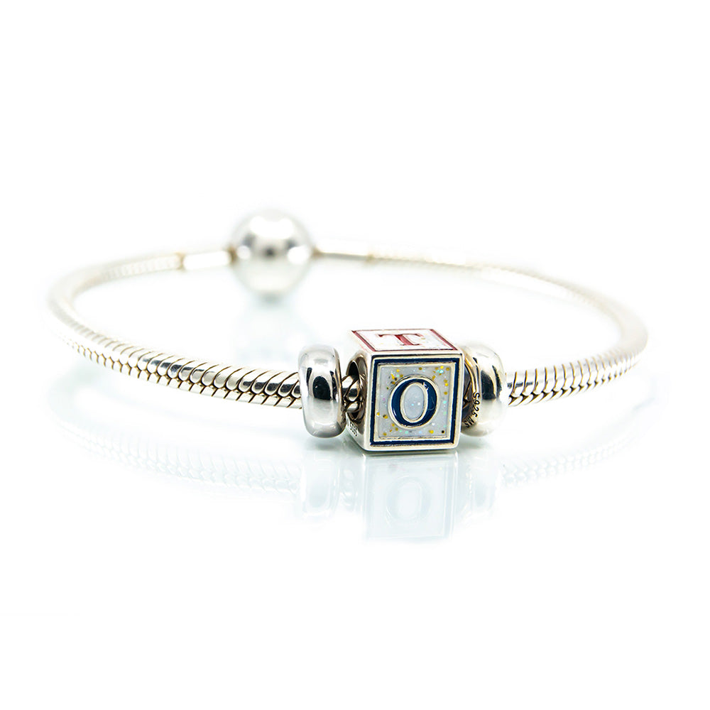 Silver bracelet with a square charm featuring the letter 'O' on a white background