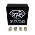 Black box with 'TAB TOYS' logo and lettered toy blocks on a white background