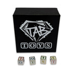 Black box with 'TAB TOYS' logo and lettered toy blocks on a white background