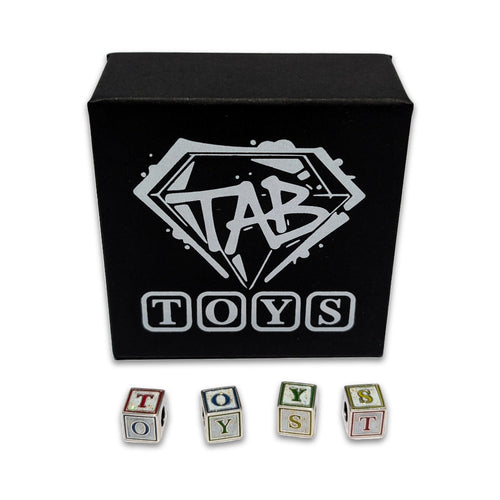 Black box with 'TAB TOYS' logo and lettered toy blocks on a white background
