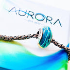 Aurora Charm Duel of Destiny Glass Bead blue; multicolor glass Bead by The Alternative Bead. Your official Aurora Charm Retailer from Germany
